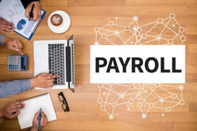 Single Touch Payroll title with overhead view of table with computer